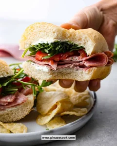 Delicious salami sandwich with fresh ingredients on a cutting board