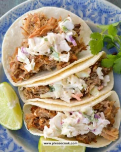 Delicious slow cooker carnitas with jalapeño slaw served on a plate.
