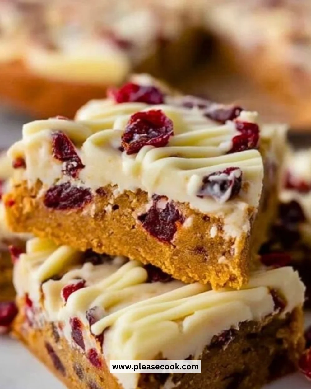 Homemade Starbucks Cranberry Bliss Bars with cream cheese frosting and cranberry topping