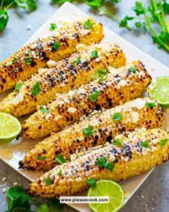 Delicious street corn topped with cheese and spices served on a cob.