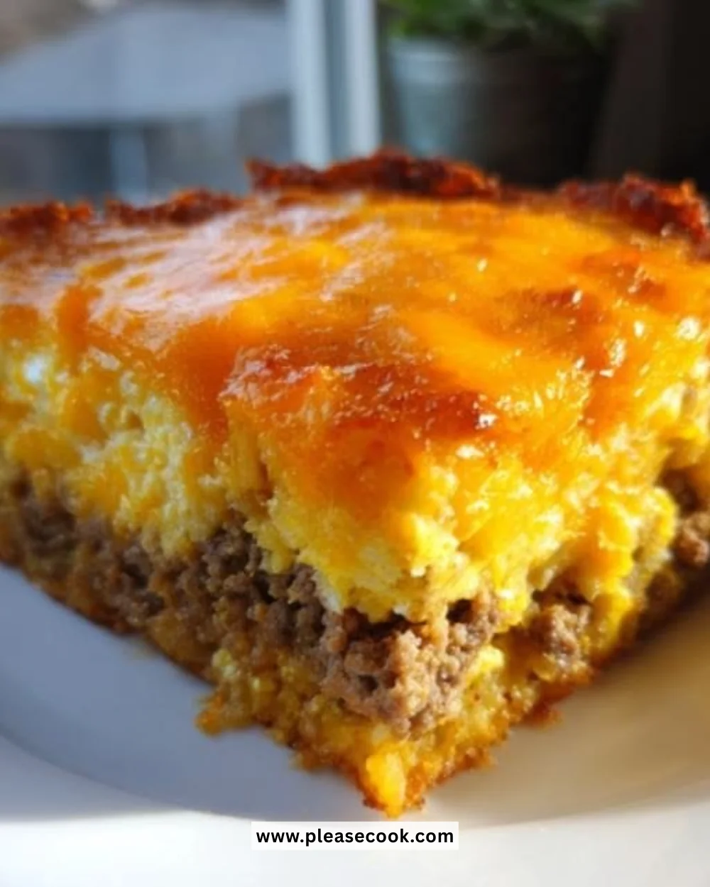 Tater tot breakfast casserole topped with cheese and veggies in a baking dish.
