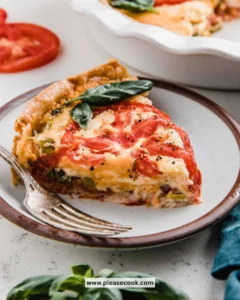 Homemade Tomato Pie with fresh tomatoes and herbs on a wooden table.