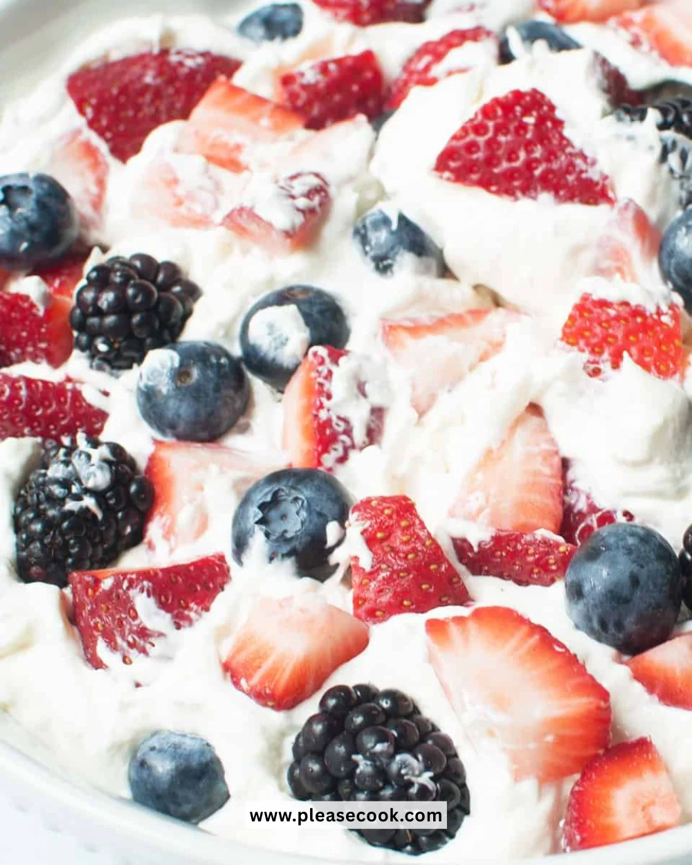 Triple Berry Cheesecake Fruit Salad featuring fresh berries and creamy cheesecake