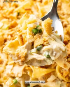 Creamy tuna noodle casserole served in a baking dish with a golden topping.