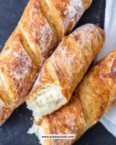 Freshly baked homemade baguette on a wooden cutting board