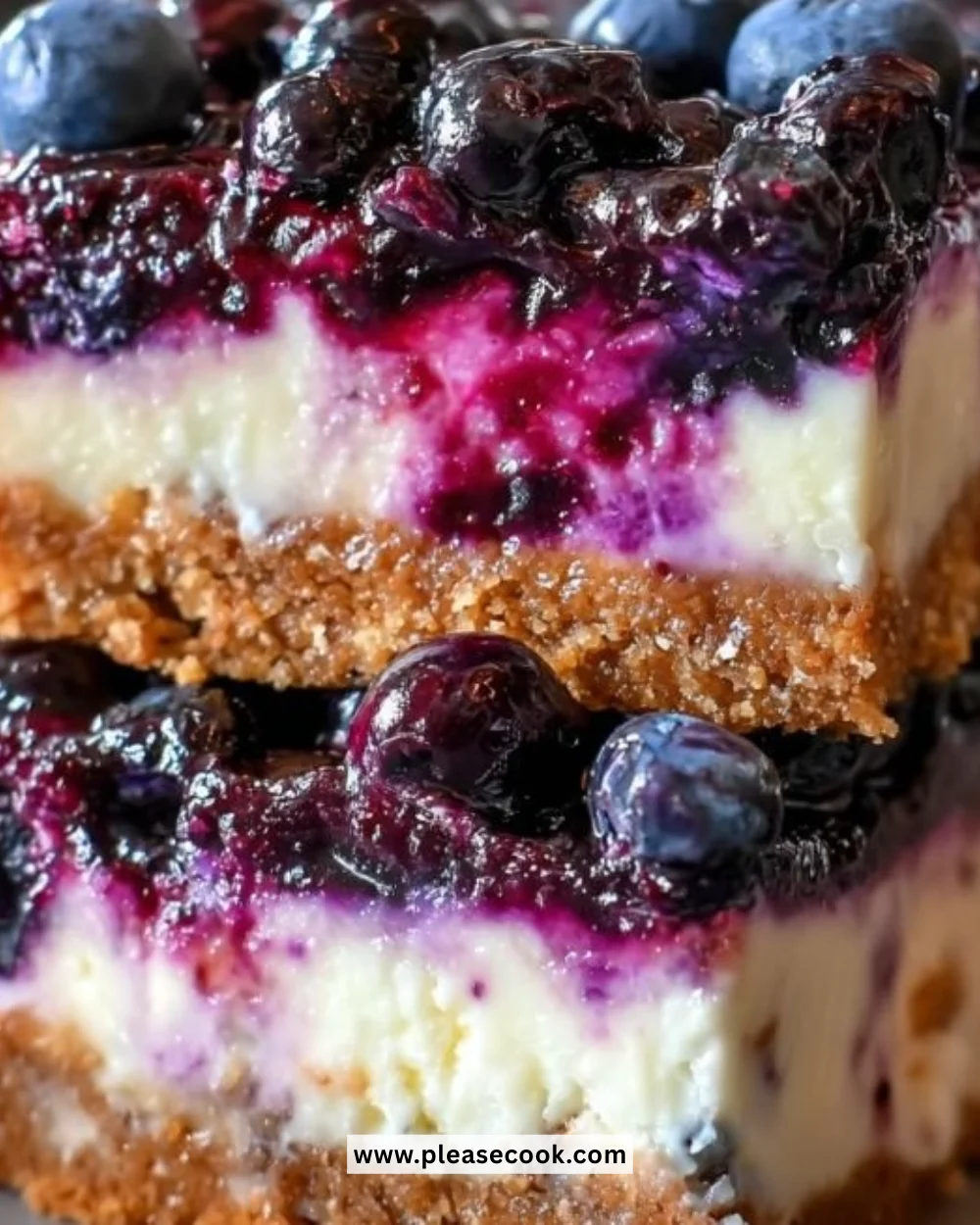 Delicious blueberry cheesecake bars topped with fresh blueberries.