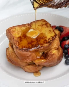 Deliciously golden Brioche French Toast topped with fresh berries and syrup.
