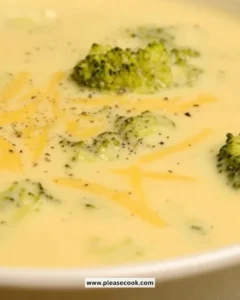 A bowl of creamy Broccoli Cheddar Soup garnished with fresh broccoli