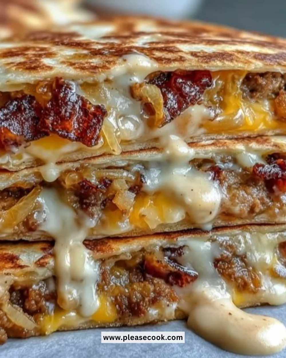 Cheesy griddled smashburger quesadillas served with dipping sauce.