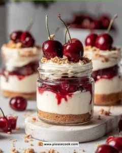 Delicious Cherry Cheesecake Jars topped with fresh cherries