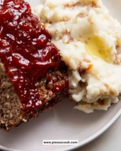 Classic meatloaf served with fluffy mashed potatoes on a plate