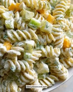 Bowl of creamy dill pickle pasta salad with fresh ingredients