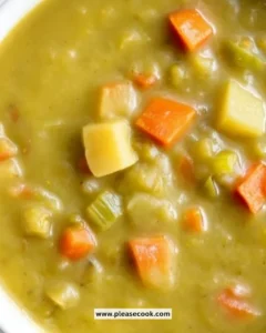Creamy split pea soup in a bowl with fresh herbs on top
