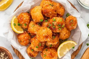 Crispy air fryer honey garlic salmon bites served with fresh herbs