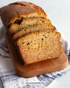 Slices of gluten-free banana bread on a wooden cutting board
