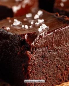 Delicious gluten-free keto avocado brownies topped with nuts and chocolate drizzle