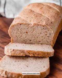 Freshly baked gluten-free sourdough bread loaf on a wooden table