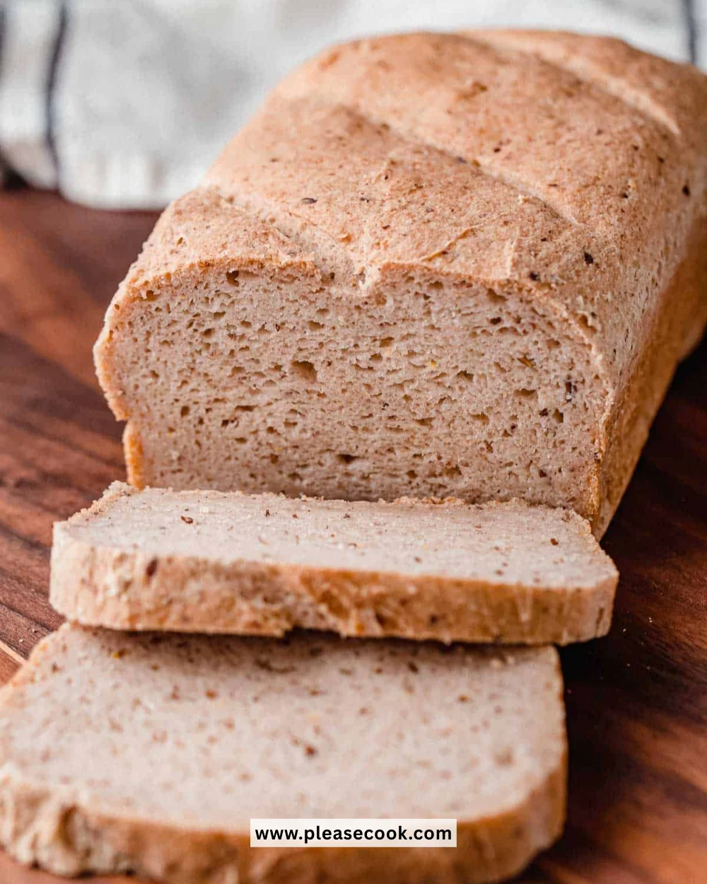 Freshly baked gluten-free sourdough bread loaf on a wooden table
