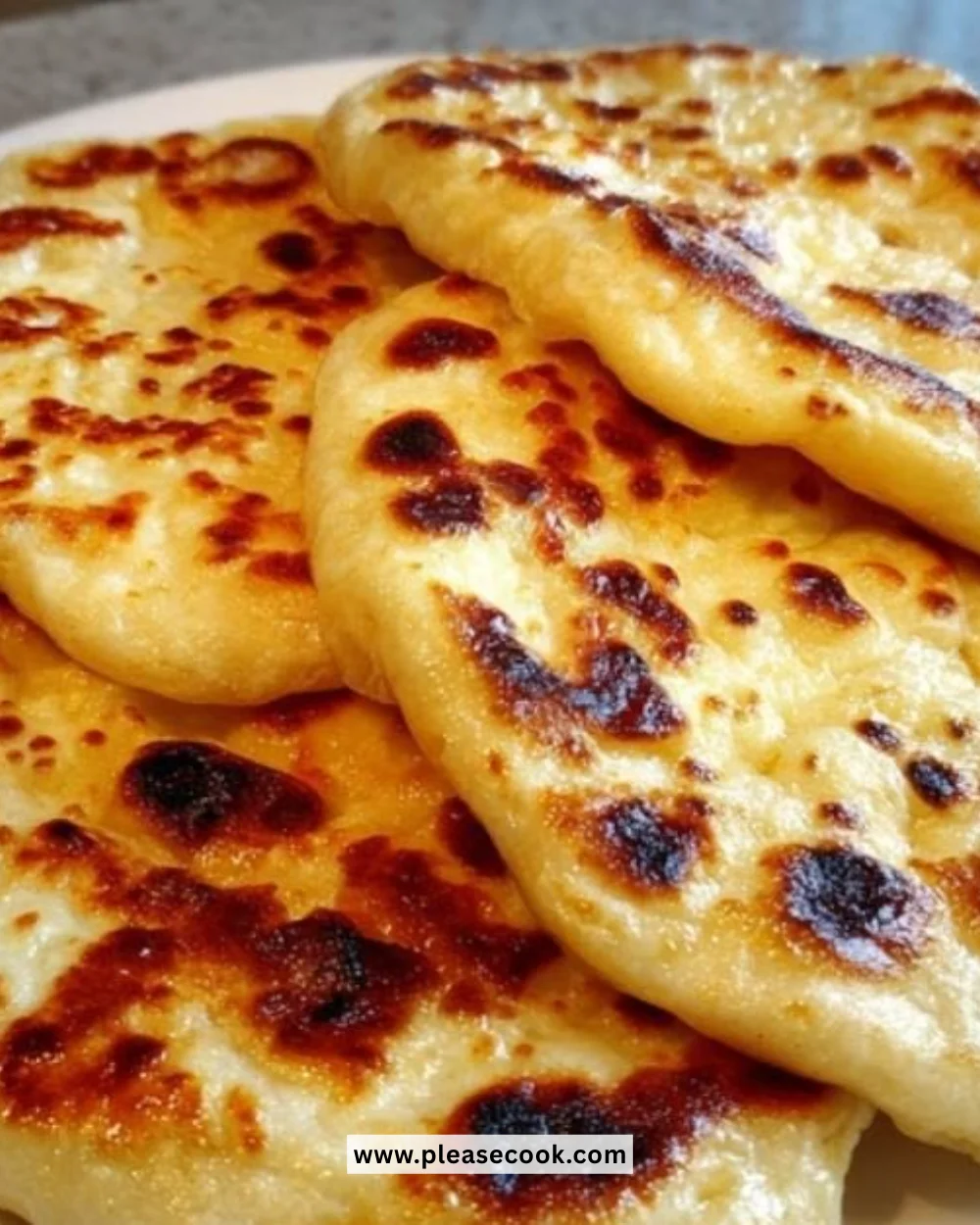 Homemade naan bread served with curry and herbs