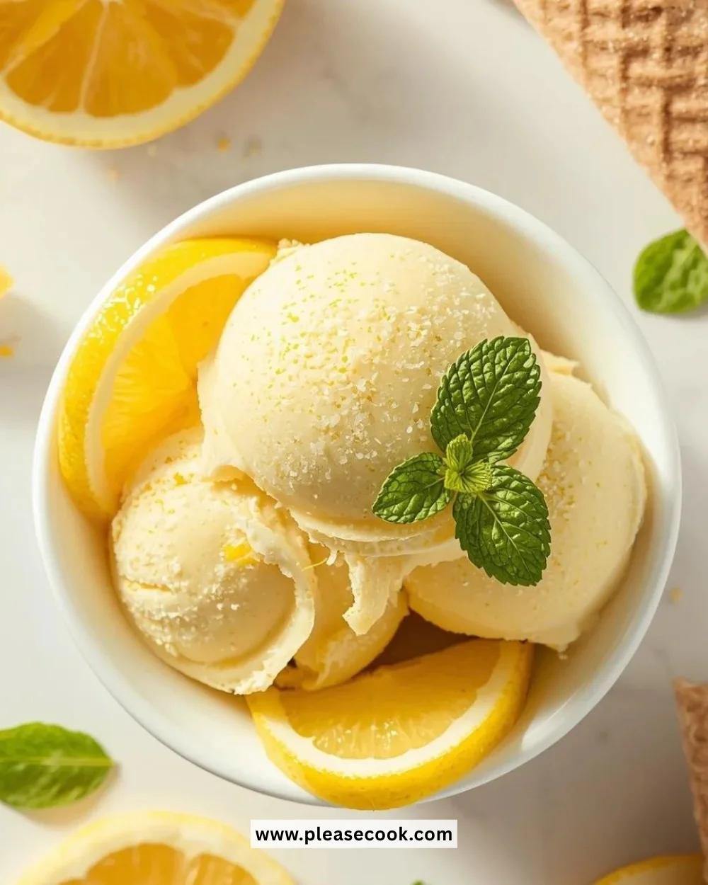 Creamy lemon ice cream in a bowl with a slice of lemon garnish