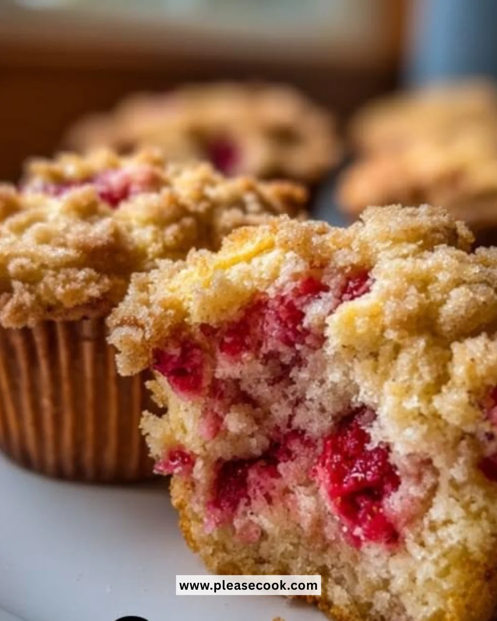 Moist and fluffy strawberry muffins with fresh berries on a rustic table