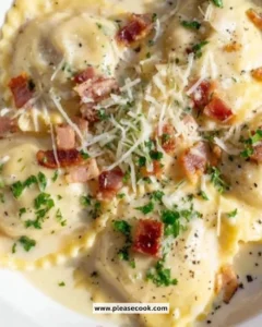 A delicious plate of Olive Garden Ravioli Carbonara with creamy sauce and herbs.