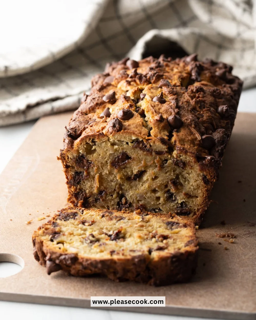 Deliciously moist Protein Banana Bread loaves served on a wooden board.