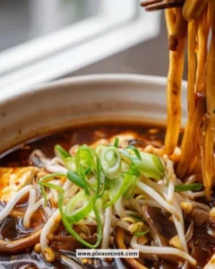 A bowl of Quick Hot and Sour Soup garnished with green onions and tofu