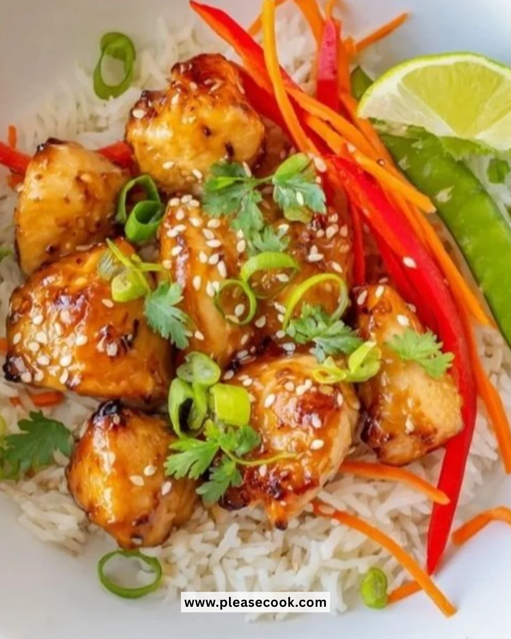 Sesame ginger chicken bowl garnished with green onions and sesame seeds