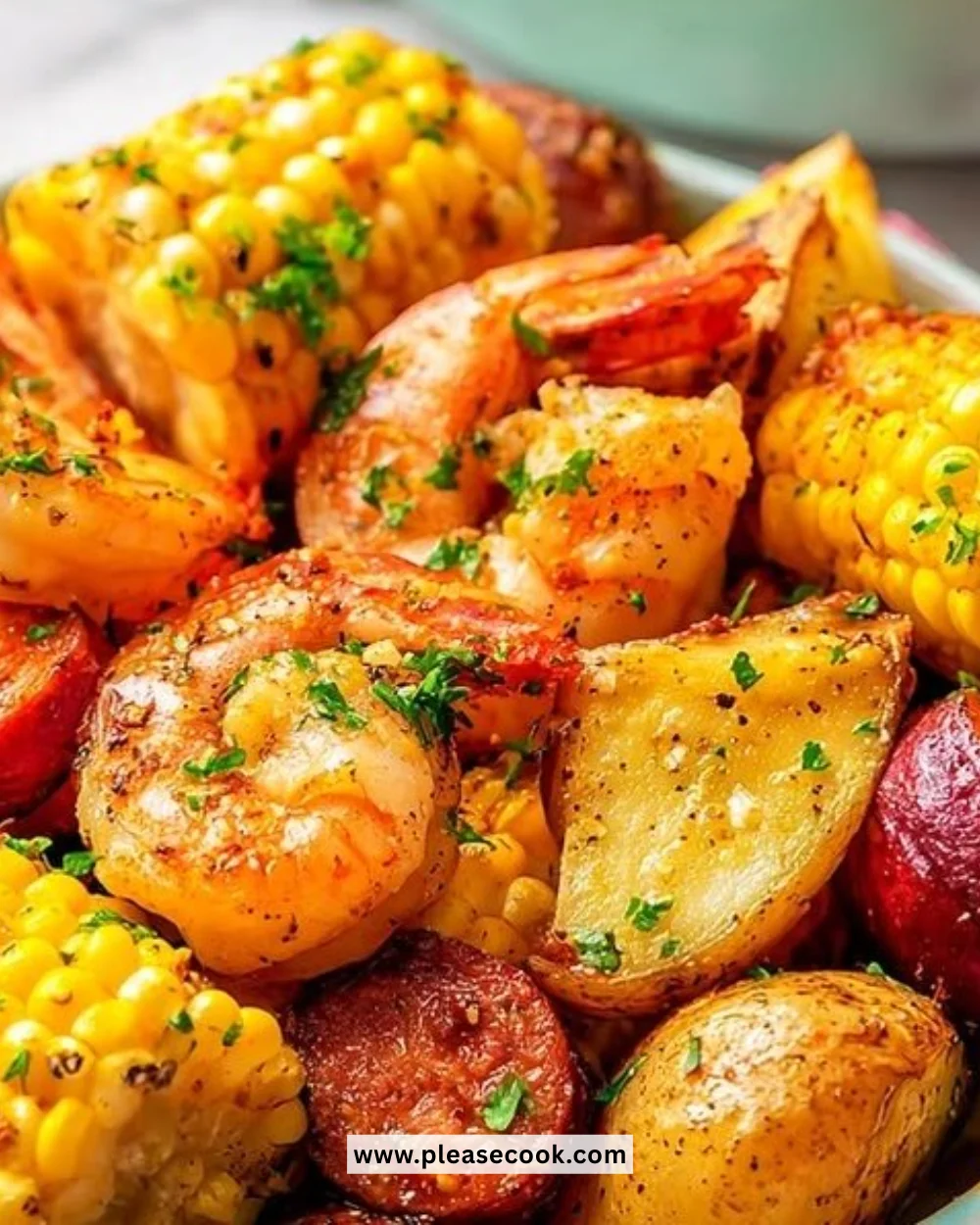 Simple oven baked shrimp boil with shrimp, potatoes, and corn