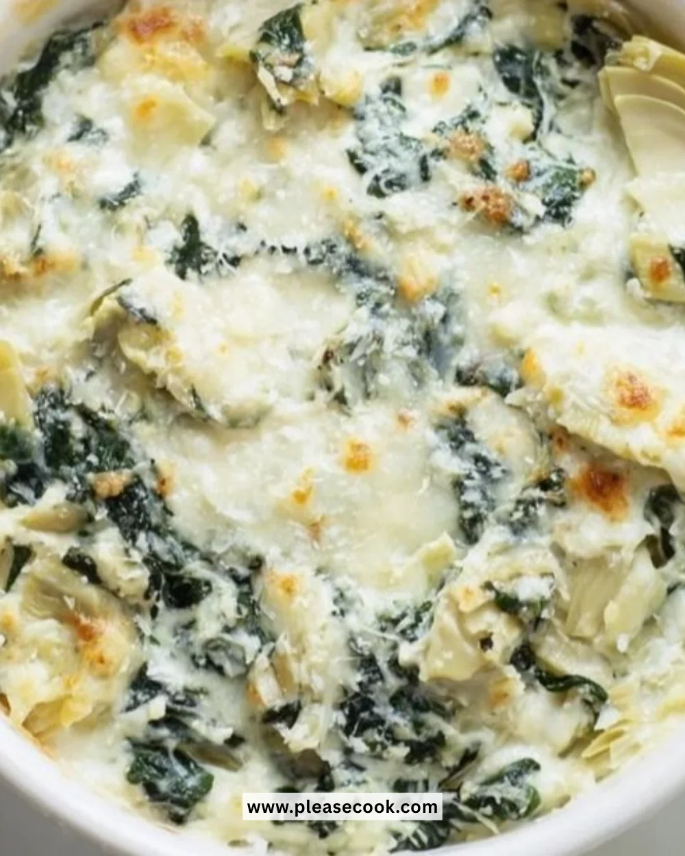 Creamy Spinach Artichoke Dip served in a bowl with tortilla chips.