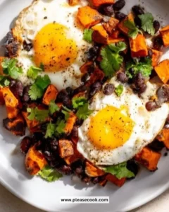 Sweet Potato Black Bean Hash served in a bowl with fresh herbs