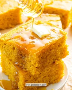 Slice of homemade sweet potato cornbread on a wooden table