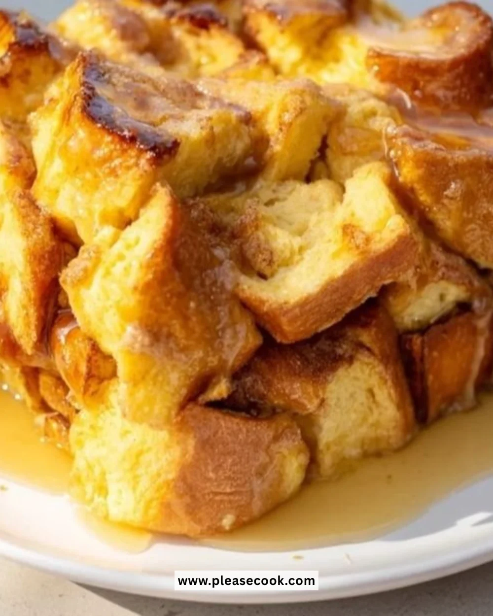 Delicious Warm French Toast Bake topped with syrup and berries