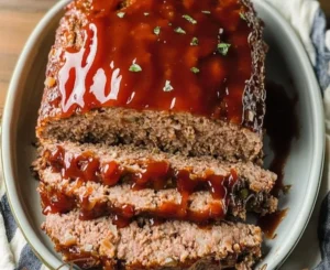 Delicious classic meatloaf served on a plate with sides