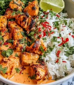 Coconut Chicken Rice Bowl topped with fresh herbs and served in a vibrant dish