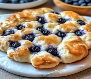 Fluffy cottage cheese blueberry cloud bread served on a white plate