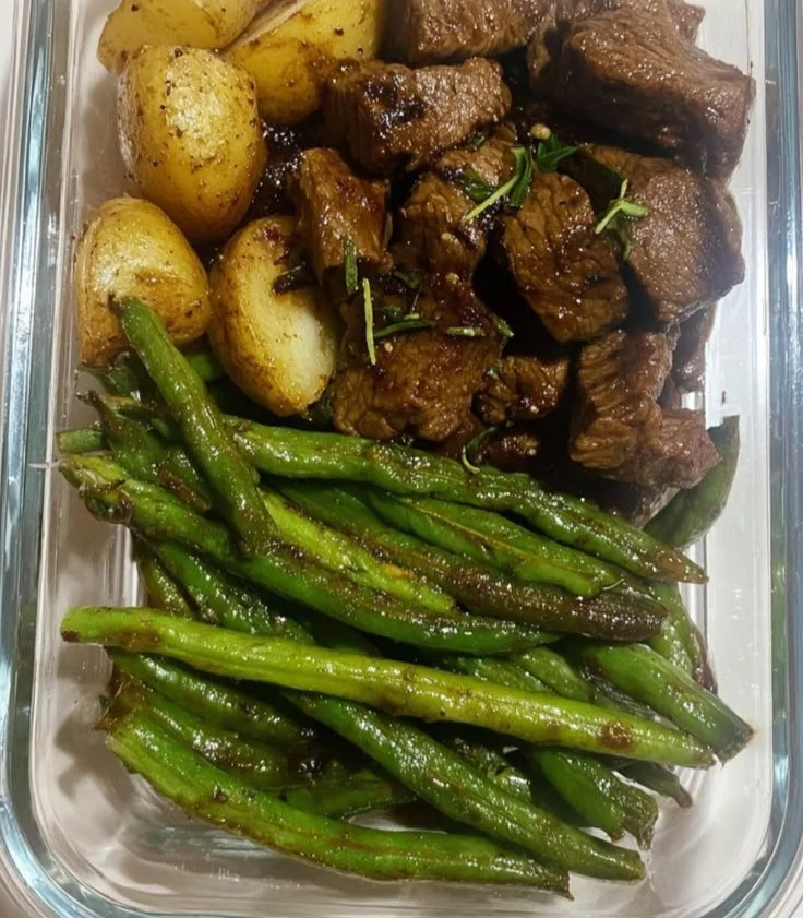Delicious garlic balsamic steak bites served with a fresh herb garnish.