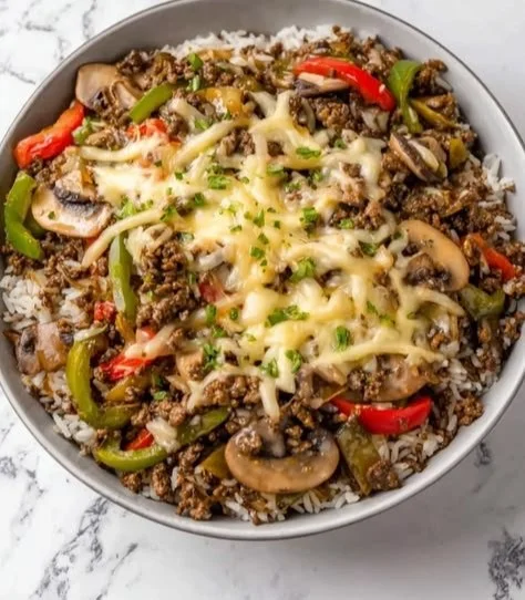 Ground Beef Philly Cheesesteak served with cheese and peppers on a hoagie roll