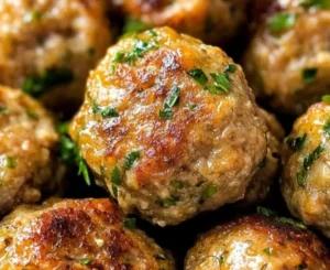 Plate of tasty ground turkey meatballs garnished with herbs