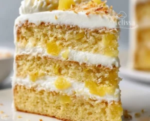 Delicious Pineapple Coconut Dream Cake topped with fresh pineapple and coconut flakes.