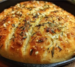 Freshly baked Rustic Garlic Rosemary Skillet Bread served in a skillet.