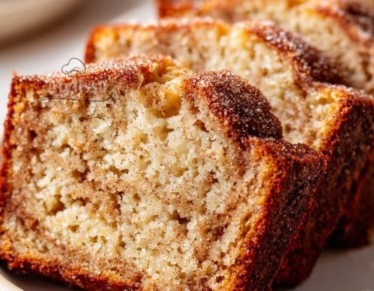 Delicious homemade snickerdoodle banana bread topped with cinnamon sugar.