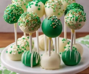 St. Patrick's Day themed cake pops decorated with green and gold sprinkles