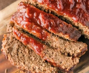 Juicy and flavorful meatloaf served with mashed potatoes and herbs.