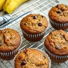 Delicious and moist banana bread muffins served on a rustic wooden table