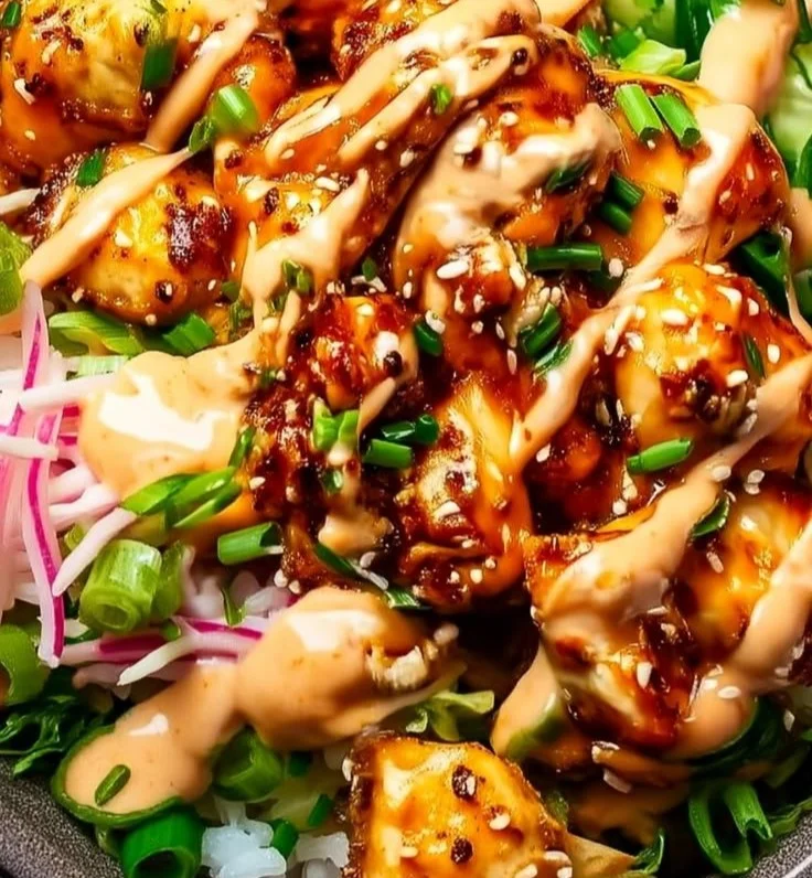Delicious Bang Bang Chicken Bowl with chicken, sauce, and fresh vegetables