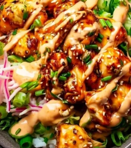 Delicious Bang Bang Chicken Bowl garnished with fresh vegetables