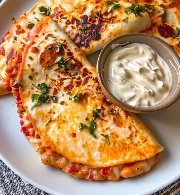 Buffalo white bean tacos topped with fresh ingredients on a wooden plate