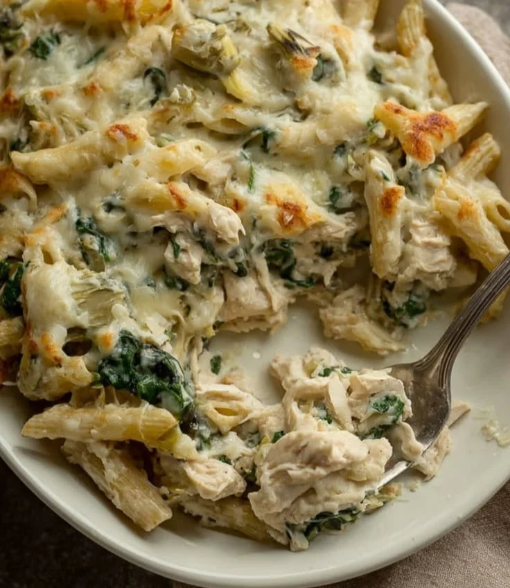 Delicious Chicken Pasta Bake topped with cheese and herbs in a baking dish